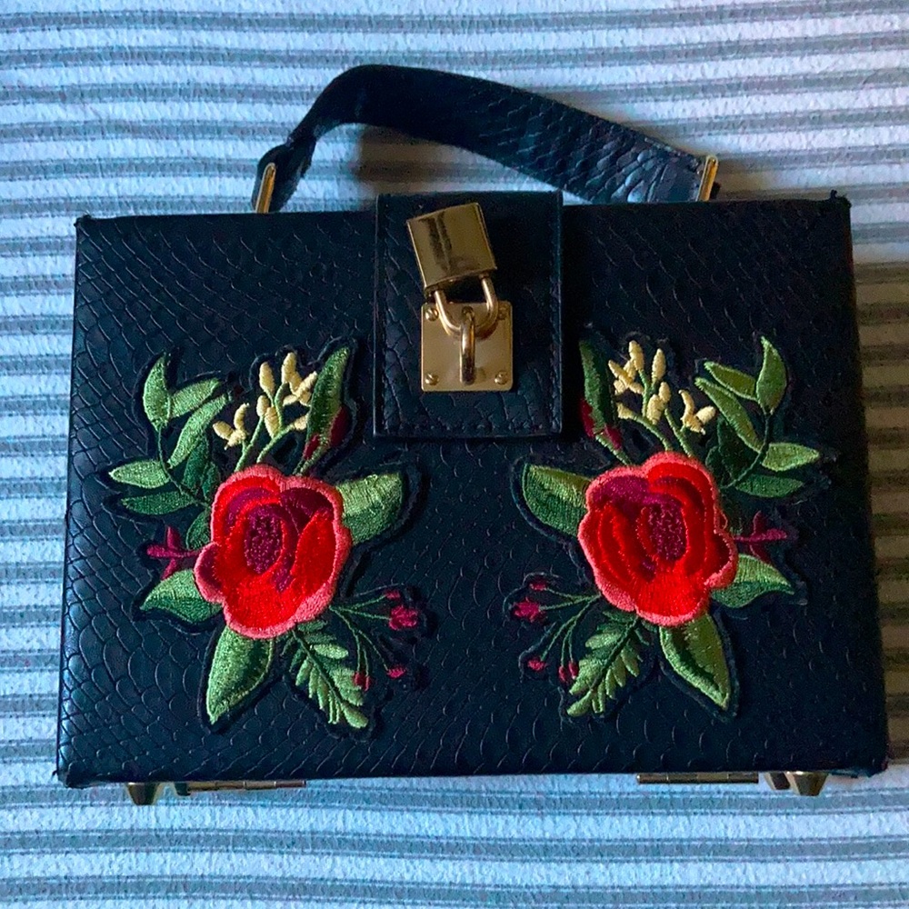 Aldo Box Clutch with rose patches in black faux leather.